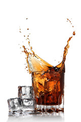 Fototapeta splash of cola in glass with ice cubes isolated on white obraz