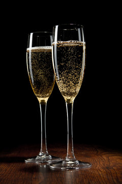 two glass with champagne on a wooden table