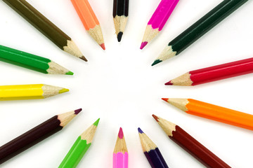 Multicolored pencils over white background