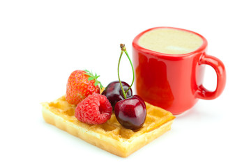cappuccino cup, waffles, cherries, strawberries and raspberries