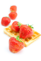 Waffles and strawberries isolated on white