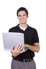 Young man standing and working  on laptop