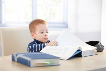 Little kid playing schoolboy at home