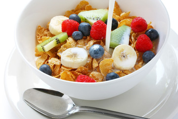 corn flakes with fresh fruits pouring milk