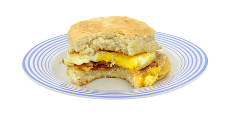 Bitten breakfast sandwich on blue plate