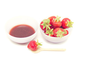 Glass pot with strawberry jam isolated on white