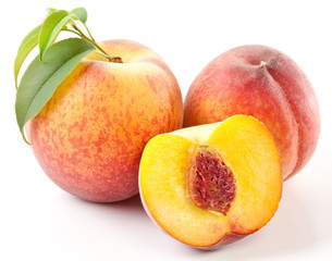Ripe peach fruit with leaves and slises