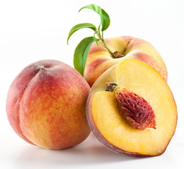 Ripe peach fruit with leaves and slises