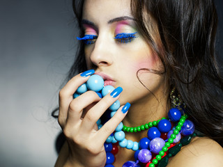 Fototapeta premium Beautiful girl with bright beads
