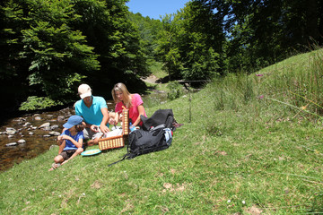 Family having a picnic by a river
