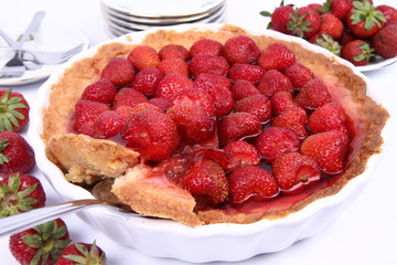 Strawberry Tart, with portion being served, on white