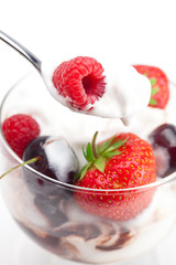 ice cream, cherries, raspberries, strawberries and spoon isolate