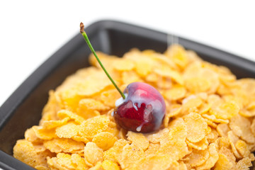 cherry,milk and flakes in a bowl