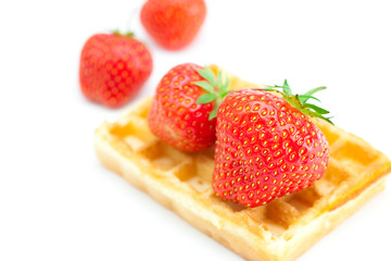Waffles and strawberries isolated on white