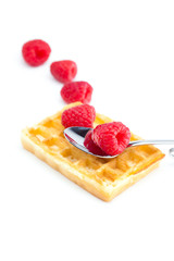 wafers,spoon and raspberry isolated on white