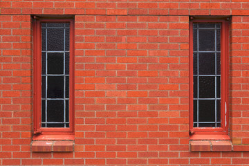 Two narrow windows in brick wall