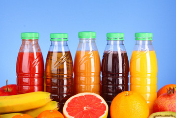 Fototapeta na wymiar fresh fruit and juices on a blue background