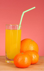 fresh oranges and juice on a red background