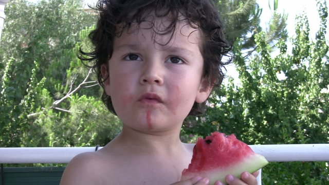 Litttle Boy eating watermelon