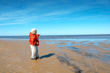 boy goes on coast sea