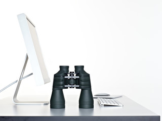 Spyglass standing on a desktop next to keyboard and computer