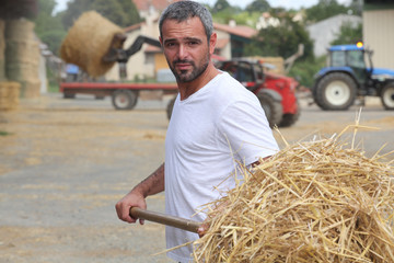 Farmer bailing hay