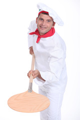 pizzaiolo holding a peel