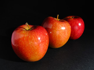 Three red apples in a row