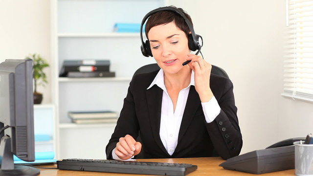 Brunette woman working with a computer