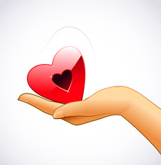 Woman’s hand is holding red heart