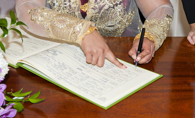 Bride Signing the Wedding Registrar