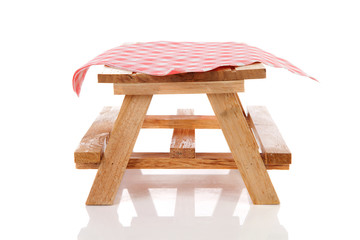 isolated empty picnic table with tablecloth