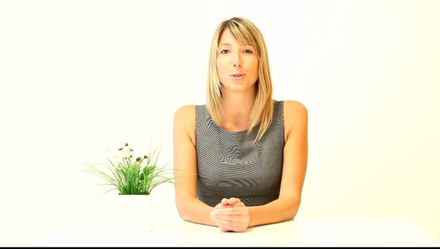 Businesswoman on white background talking to camera