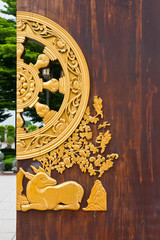 Golden animal on brown wood door