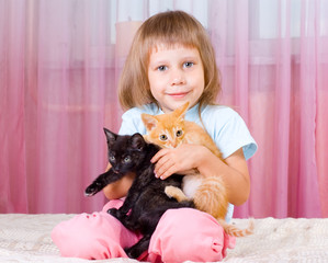 Girl hugs ginger kittens