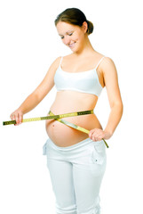 Fototapeta na wymiar pregnant woman measuring belly