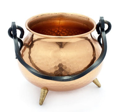 Shiny copper cauldron isolated on white background