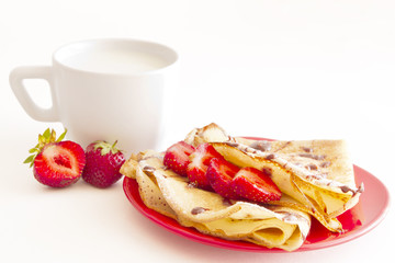 sweet pancakes with strawberry and cup of milk