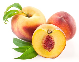 Ripe peach fruit with leaves and slises