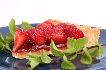 Piece of Strawberry Tart decorated with mint twigs