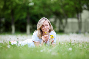Fototapeta premium Young blond woman in the park