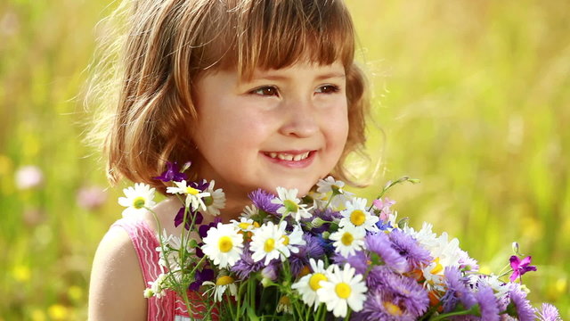 Little girl with flowers laughing