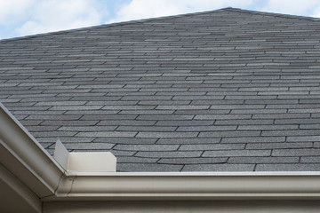 Rain Gutters Splash Guard on Roof against blue sky