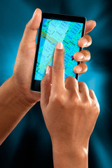 A woman use a mobile phone to search a street on a map