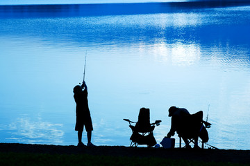 Father and son fishing at daybreak