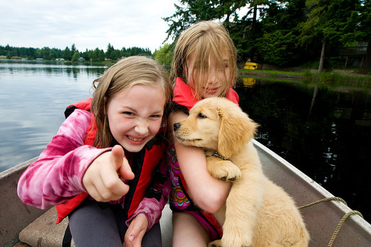 kids in a boat with a puppy