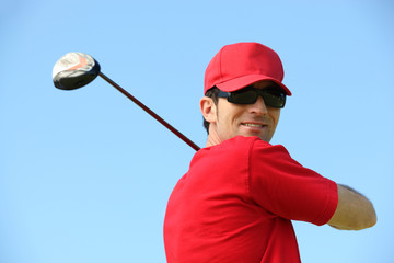 Golfer head and shoulders smiling.