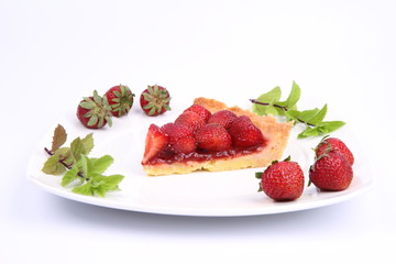 Piece of Strawberry Tart decorated with strawberries and mint