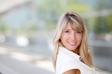 Portrait of beautiful blond woman in town