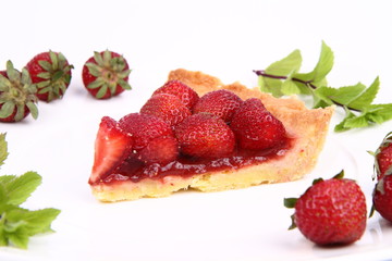 Piece of Strawberry Tart decorated with strawberries and mint